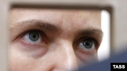 Jailed Ukrainian pilot Nadia Savchenko looks out from a defendants' cage during her trial in a Russian court on March 3. 