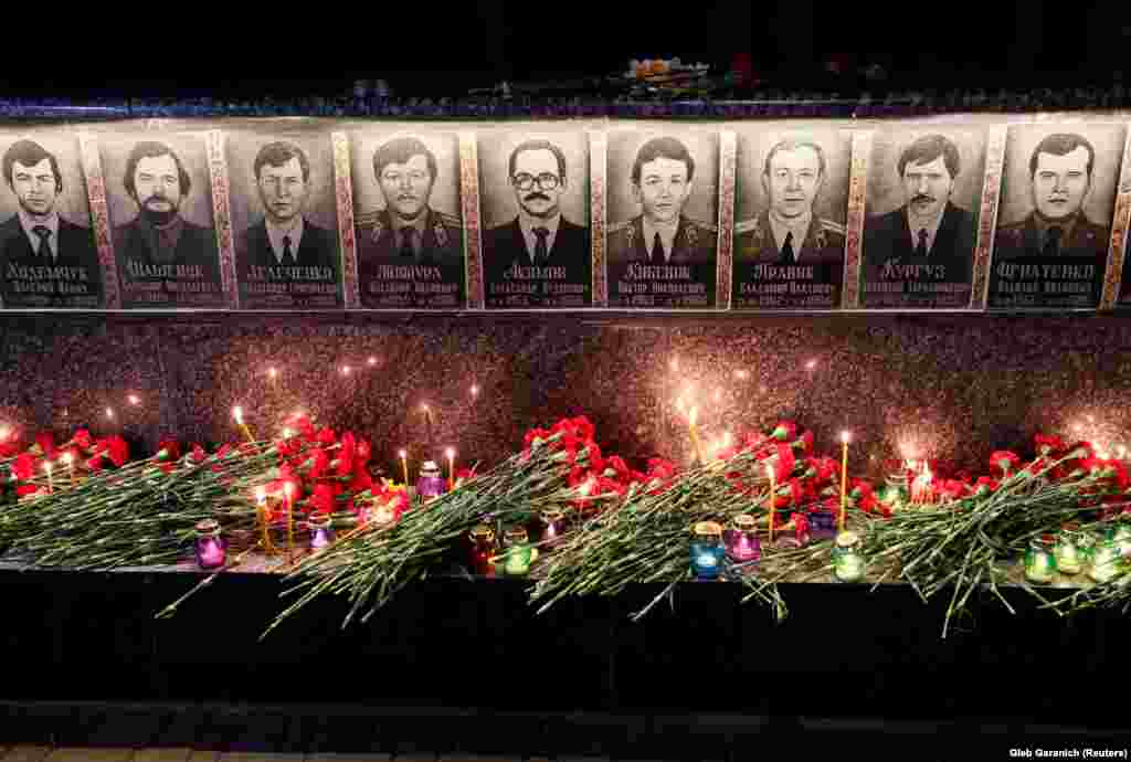 Flowers are placed in front of a memorial in the Ukrainian city of Slavutych dedicated to firefighters and workers who died in the Chernobyl nuclear disaster.