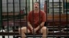 Russian arms dealer Viktor Bout sits in a Thai court's detention room in Bangkok in 2009. He was extradited to the United States the following year. 