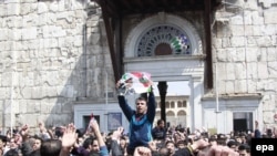 Syrians shout slogans during a pro-government rally outside the Umayyad Mosque in the old city of Damascus on March 25.