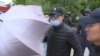 Masked 'Umbrella Men' Strike Kazakh Journalists Again