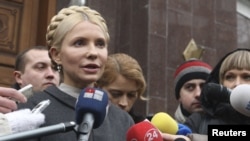 Former Ukrainian Prime Minister Yulia Tymoshenko talks to the media as she arrives at the state prosecutor's office in Kyiv on December 15