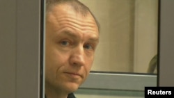 Eston Kohver is shown in a defendants' cage during a court hearing in Pskov, Russia, on June 2.