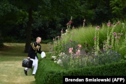 A U.S. marine carries the nuclear football at the U.S. ambassador's residence in London on July 12, 2018.