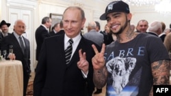 Vladimir Putin poses for a photo with rapper Timati during a meeting with his campaign activists in Moscow in 2012.