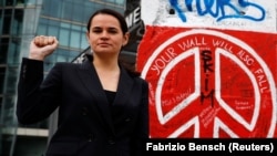 Belarusian opposition leader Svyatlana Tsikhanouskaya poses on October 6 in front of remains of the Berlin Wall at Potsdamer Platz that were repainted by Belarus activists during a rally to protest against police violence and to reject the results of the country's recent presidential election.