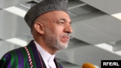 Hamid Karzai speaks to reporters after voting in Kabul on August 20.