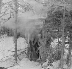 Finnish fighters peek out from a sauna during the war.