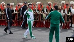 Turkmen President Gurbanguly Berdymukhammedov (center) waves to the media during the starting ceremony of a 500-day nationwide horse race at the historical site of Nisa just outside Ashgabat on May 5 in preparation for the 2017 Asian Indoor and Martial Arts Games.