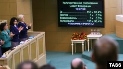 Members of the Federation Council, Russia's upper house of parliament, applaud after voting to annex Crimea in Moscow on March 21.