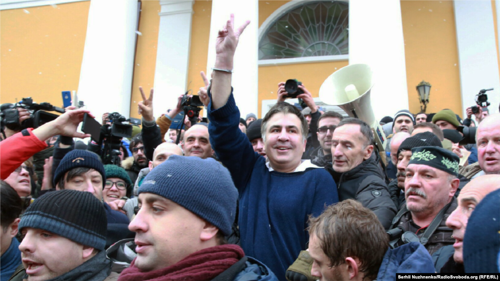 Saakashvili surrounded by his supporters after being freed from police detention