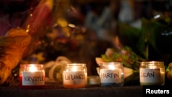 Candles are lit for those who died in the Boston Marathon bombings and the subsequent police manhunt at a memorial on Boylston Street in Boston on April 21.