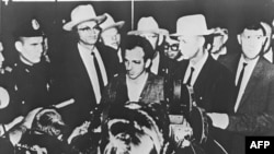 Lee Harvey Oswald appears at a press conference after his arrest in Dallas on November 22, 1963.