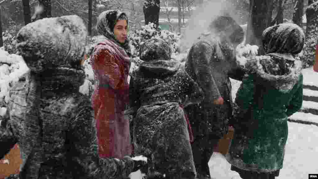 Young people play in the snow in a park in Iran&#39;s capital, Tehran.