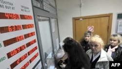 People exchange money inside an exchange office in Minsk 