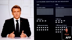 President Emmanuel Macron addresses the nation on live TV, with a graphic outlining a projection of Russia's military strength shown on screen on March 5.