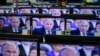 TV screens showing Russian President Vladimir Putin during an annual nationwide Q&A on April 16.