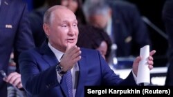 Russian President Vladimir Putin greets participants as he attends the 68th FIFA Congress in Moscow on June 13.