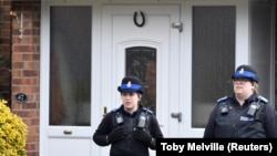 British police stand guard outside of the home of former Russian military intelligence officer Sergei Skripal in Salisbury on March 6.