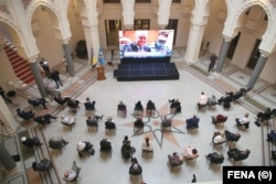 People in Sarajevo watch a live broadcast from The Hague to learn the verdict for Bosnian Serb military chief Ratko Mladic, on June 8, 2021.