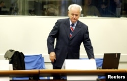 Former Yugoslav President Slobodan Milosevic appears before the tribunal in The Hague in 2004.