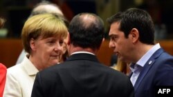 German Chancellor Angela Merkel (left), French President Francois Hollande (center), and Greek Prime Minister Alexis Tsipras confer during intense bailout negotiations in Brussels on July 12. 