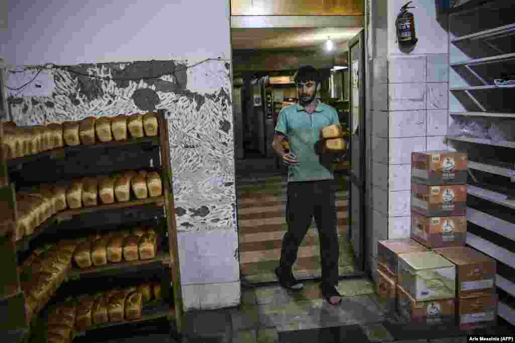 Loaves awaiting pickup in the bakery. The bakery also operates a delivery service for those who are unable to pick up the bread themselves. One driver said: &quot;We deliver every day, whatever time people ask us to, at least six to eight times a day.... Danger is everywhere but we try to deliver wherever we can.&quot;