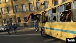 Antigay protesters destroy a bus carrying gay activists during the "Rainbow flashmob" organized in St. Petersburg on May 17.