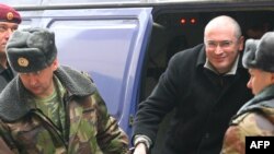 Russian police lead Mikhail Khodorkovsky out of a police van and into a Moscow court on March 4.