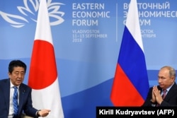 Russian President Vladimir Putin (right) meets with Japanese Prime Minister Shinzo Abe in Vladivostok on September 10.