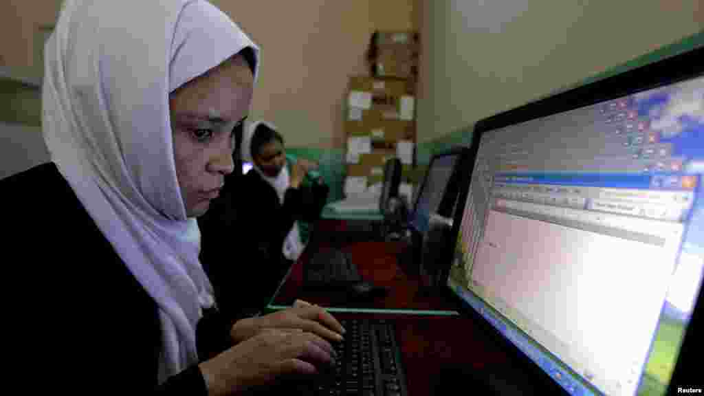 Blind students use computers during a lesson at the school.