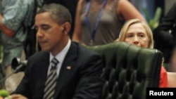 U.S. Secretary of State Hillary Clinton looks on from behind President Barack Obama's seat during an ASEAN-US Summit in 2011.