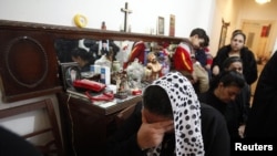 A Coptic Orthodox Christian cries for her relatives who were victims of the January 1 bomb attacks outside a Coptic church in Alexandria.