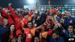 Cricket players of Islamabad United celebrate their victory in the final of the Pakistan Super League in 2018.