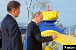 Then Prime Minister Vladimir Putin (right) and Gazprom CEO Aleksei Miller attend a gas-pipeline opening ceremony in the far eastern city of Vladivostok in 2011.