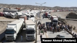 Trucks wait at the border post in Taftan to cross into Iran after Pakistan sealed its border as a preventive measure following the coronavirus outbreak on February 25, 2020.