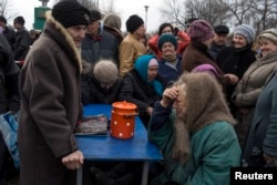 People queue for free food distributed by pro-Russian rebels near the town of Debaltseve last month.