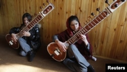 Students at the Kabul Music Academy play sitars.