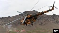 An Afghan National Army (ANA) helicopter flies over a military base during an exercise mission on the outskirts of Kabul on March 16.