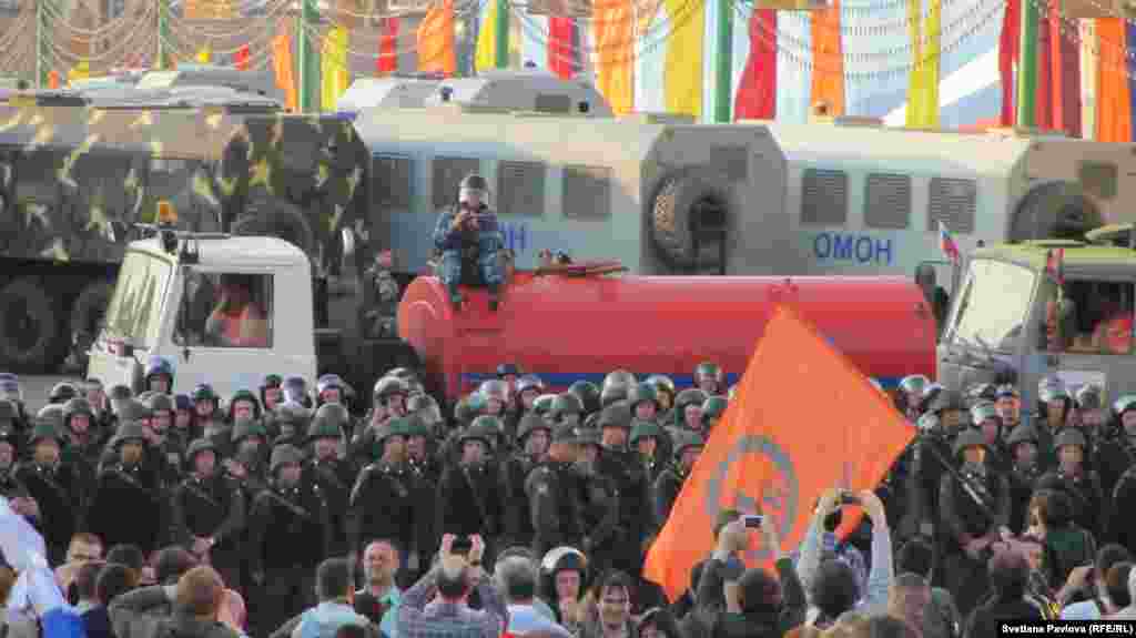 Security forces stand guard near the protest.