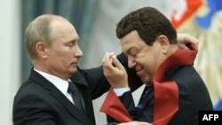 Russian President Vladimir Putin awards a medal to singer Iosif Kobzon (right) during a ceremony in the Kremlin in Moscow in August 2012. 