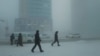 Pedestrians walk along a street in the city of Yakutsk in Siberia, which has been hit with an extreme cold snap.