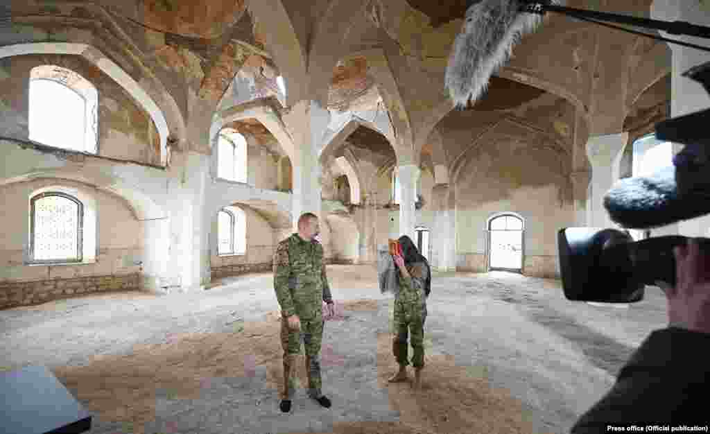 Azerbaijani President Ilham Aliyev and his wife -- who is also the country&#39;s vice president -- pose with a Koran inside the main mosque on November 22. Lohr adds that he is &quot;of course worried because it&#39;s not easy to overcome all these emotions connected to the war&quot; with &quot;so many injustices happening there.&quot;