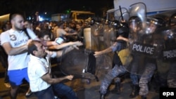 Protesters clash with police on July 20, 2016, near a police station that was seized by armed men a few days earlier.