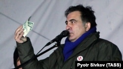 Mikheil Saakashvili speaks to supporters as they camp out outside parliament in Kyiv on December 6.