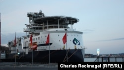 A specially designed ship with a helicopter pad prepares to take supplies from Stavanger harbor to an offshore oil platform.