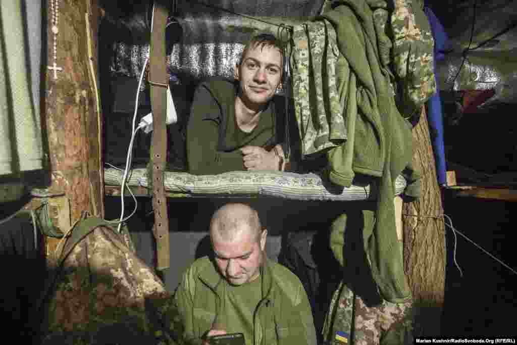 Soldiers rest in a dugout a few hundred meters from territory controlled by the separatists.