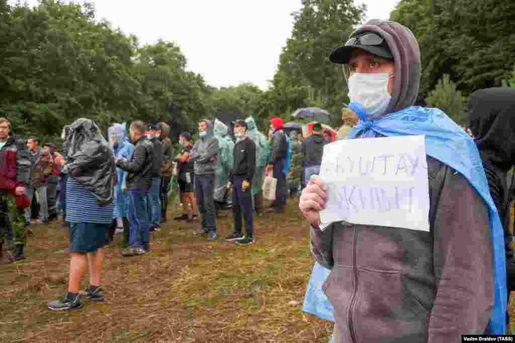 People take part in a protest on August 16. The sign reads, &quot;Kushtau, live!&quot;.