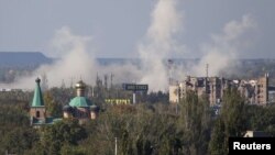 Smoke rises near Donetsk's Sergei Prokofiyev International Airport , which has been the scene of heavy fighting in recent days. 