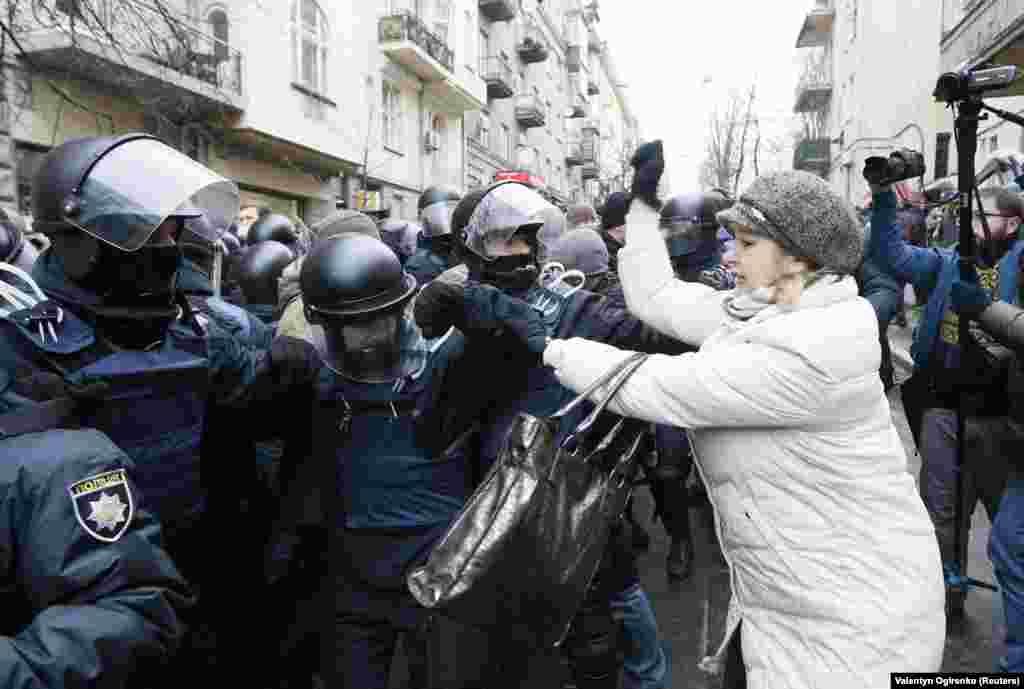 A woman attacks police as they attempt to clear the way for a police van holding Saakashvili.&nbsp;